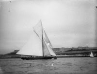 YACHT WITH SIX CREW MEMBERS, CITADEL IN BACKGROUND