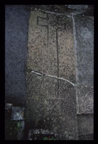 Stone with inscribed cross from porch at Bovey Tracey church