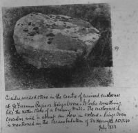 A mill stone in an enclosure at King's Oven