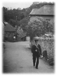 A lustleigh postman delivering through the village