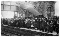 1WW SERVICEMEN, NEW RECRUITS, WIVES AND CHLDREN WAIT FOR THE TRAIN AT AXMINSTER RAILWAY STATION;  