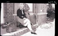 Marjorie Taylor and companion sitting in the sun outside Gratton, Yelverton