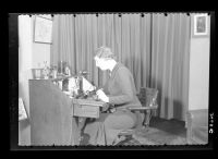 Sydney Taylor's wife, Marjorie, making a  telephone call.