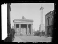 Plaza featuring a large column and a building with fine architecture