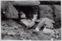 John Waterfield finding shelter to read under the rocks at Hound Tor