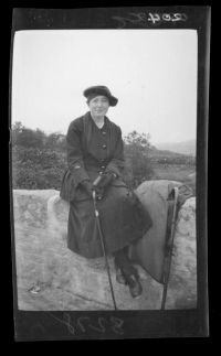 One of the Taylor women sitting on a wall