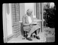 Marjorie Taylor reading on the porch at Gratton 