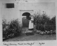 Mother and Child Standing in Doorway to Cottage at Stiniel