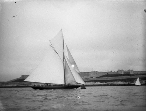 YACHT WITH SIX CREW MEMBERS, CITADEL IN BACKGROUND