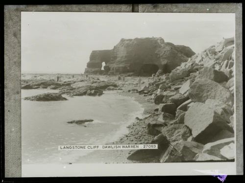 People enjoying explore rock pools at low tide near Langstone Cliff, Dawlish Warren