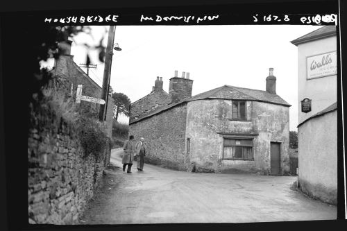 Mr. H.E.Mitchell and Mr. H.M.Osborne looking at houses scheduled for demolition in Horrabridge in th