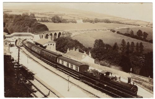 Steam Train Passing Through Station