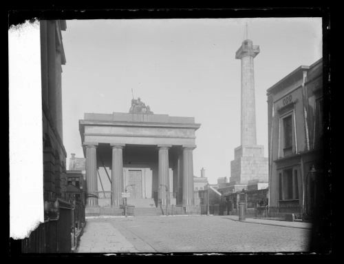 Plaza featuring a large column and a building with fine architecture