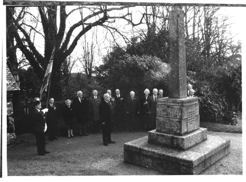 Members of the British Legion standing before the Manaton War Memorial