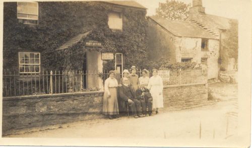 Family group outside the old Post Office in Lydford