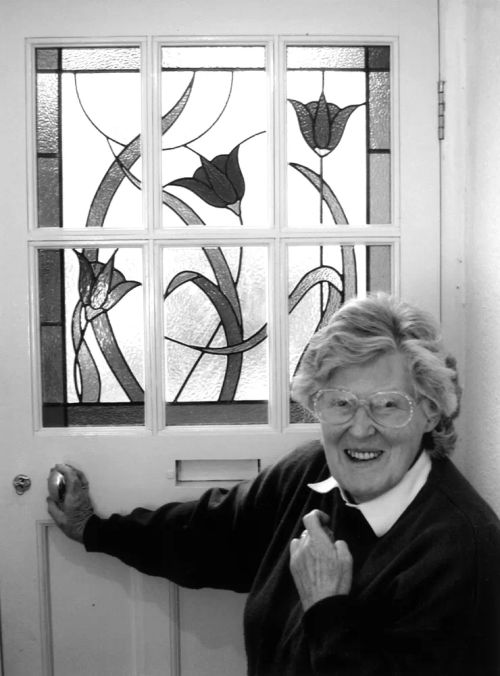 Anne Beaumont with her stained glass window